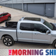 A photo of Ford's electric F-150 Lightning pickup charging up a Mustang Mach-E.